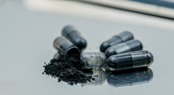 Activated charcoal capsule pills. Selective focus on black powder of activated charcoal on stainless steel drug tray. Medicinal carbon for relieves diarrhea,  food or drug poisoning,  flatulence.,Image: 528954541, License: Royalty-free, Restrictions: , Model Release: no, Credit line: Artinun Prekmoung / Panthermedia / Profimedia