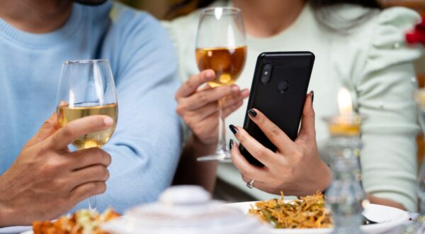 close up shot of couple hands using mobile phone by having drinks during candlelight dinner - concept of wedding anniversary celebration, cyberspace and dating application.,Image: 755088609, License: Royalty-free, Restrictions: , Model Release: no, Credit line: lakshmiprasad S / Alamy / Alamy / Profimedia