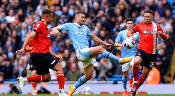 Manchester City's Mateo Kovacic (centre) battles for the ball with Luton Town's Carlton Morris (left) and Jordan Clark during the Premier League match at the Etihad Stadium, Manchester. Picture date: Saturday April 13, 2024.,Image: 864500977, License: Rights-managed, Restrictions: EDITORIAL USE ONLY No use with unauthorised audio, video, data, fixture lists, club/league logos or "live" services. Online in-match use limited to 120 images, no video emulation. No use in betting, games or single club/league/player publications., Model Release: no, Credit line: Martin Rickett / PA Images / Profimedia
