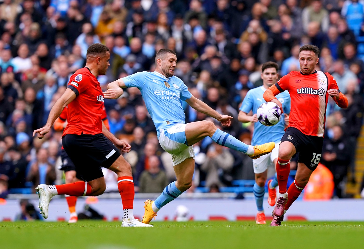 Manchester City's Mateo Kovacic (centre) battles for the ball with Luton Town's Carlton Morris (left) and Jordan Clark during the Premier League match at the Etihad Stadium, Manchester. Picture date: Saturday April 13, 2024.,Image: 864500977, License: Rights-managed, Restrictions: EDITORIAL USE ONLY No use with unauthorised audio, video, data, fixture lists, club/league logos or "live" services. Online in-match use limited to 120 images, no video emulation. No use in betting, games or single club/league/player publications., Model Release: no, Credit line: Martin Rickett / PA Images / Profimedia