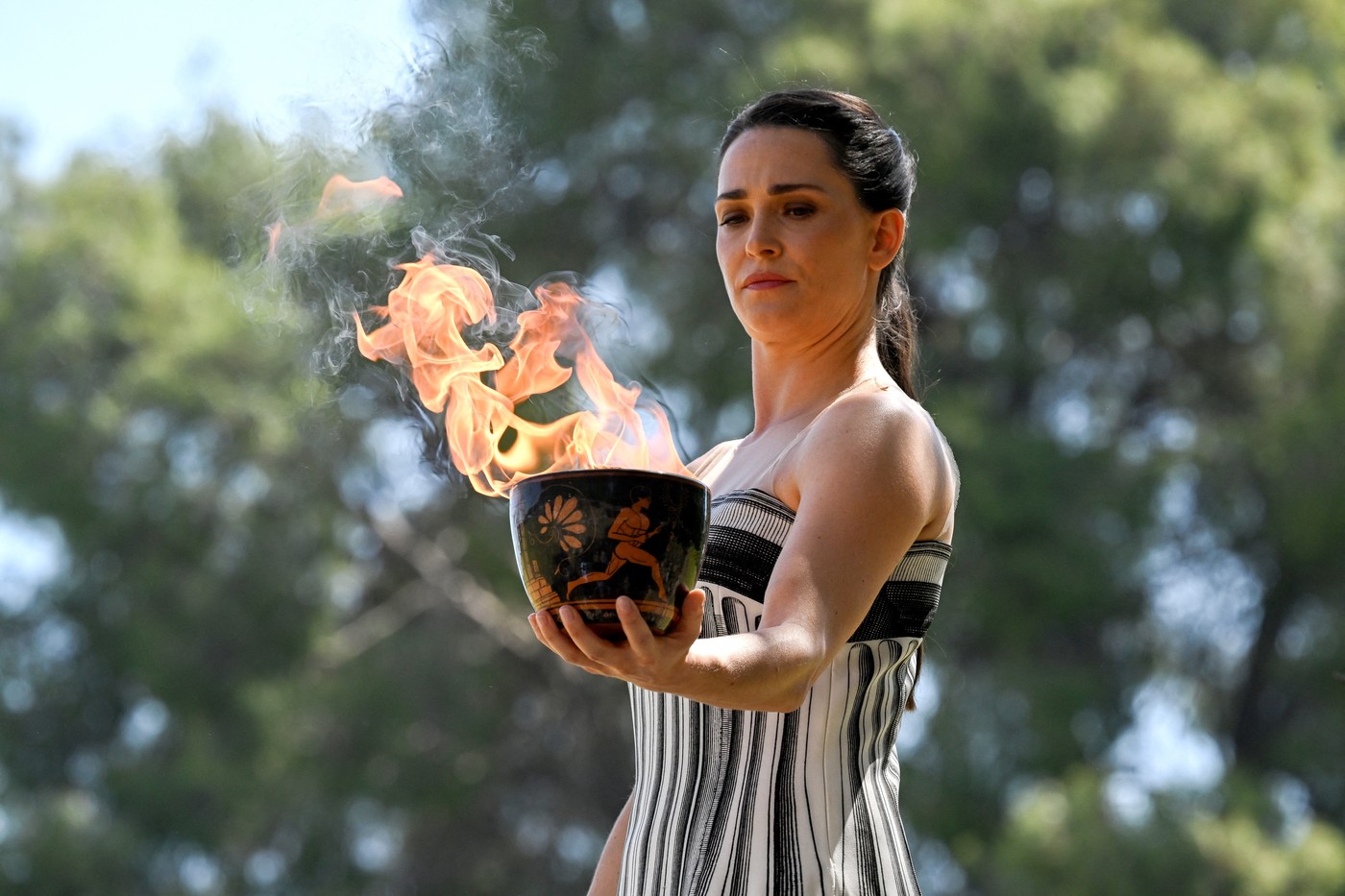 Greek actress Mary Mina, playing the role of the High Priestess, holds the Olympic flame during the rehearsal of the flame lighting ceremony for the Paris 2024 Olympics Games at the ancient temple of Hera on the Olympia archeological site, birthplace of the ancient Olympics in southern Greece, on April 15, 2024.,Image: 864966570, License: Rights-managed, Restrictions: , Model Release: no, Credit line: Aris MESSINIS / AFP / Profimedia