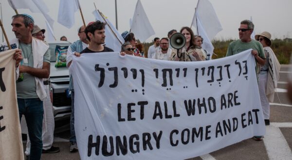 Activists hold a sign during a protest near the Gaza strip border in Israel on Friday, April 26, 2024. Rabbis belonging to the U.S.-based organization "Rabbis for Ceasefire," along with Israeli rabbis and activists, gathered near the Gaza border in an attempt to make a symbolic delivery of aid through Erez Crossing. The Israeli police stopped the procession, prevented the delivery of aid, and arrested seven rabbis and activists. The activists are calling for a permanent ceasefire and an end to the human-made starvation in Gaza. Israel-Gaza border , Erez crossing, on April 26, 2024.,Image: 868327935, License: Rights-managed, Restrictions: , Model Release: no, Credit line: Middle East Images/ABACA / Abaca Press / Profimedia