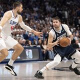 Dallas Mavericks guard Luka Doncic steps back in front of Los Angeles Clippers center Ivica Zubac (40) during Game 4 of an NBA basketball first-round playoff series Sunday, April 28, 2024, in Dallas. (AP Photo/Jeffrey McWhorter)