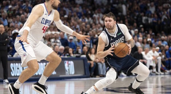Dallas Mavericks guard Luka Doncic steps back in front of Los Angeles Clippers center Ivica Zubac (40) during Game 4 of an NBA basketball first-round playoff series Sunday, April 28, 2024, in Dallas. (AP Photo/Jeffrey McWhorter)