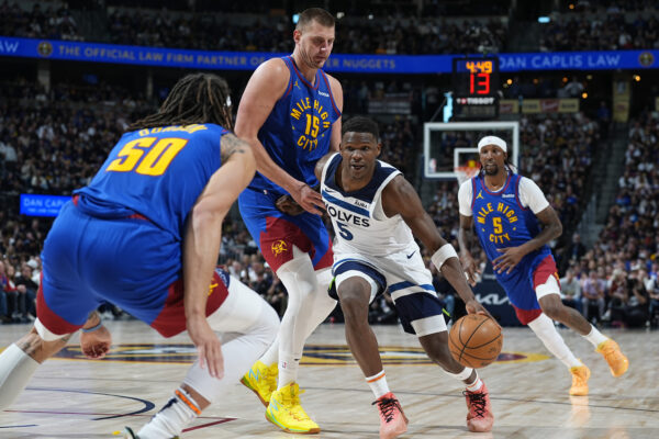 Minnesota Timberwolves guard Anthony Edwards (5) drives past Denver Nuggets center Nikola Jokic (15) as forward Aaron Gordon (50) blocks the lane in the second half of Game 1 of an NBA basketball second-round playoff series Saturday, May 4, 2024, in Denver. (AP Photo/David Zalubowski)