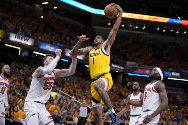 Indiana Pacers forward Obi Toppin (1) drives to the basket over New York Knicks center Isaiah Hartenstein (55) and forward Precious Achiuwa (5) during the second half of Game 6 in an NBA basketball second-round playoff series, Friday, May 17, 2024, in Indianapolis. (AP Photo/Michael Conroy)