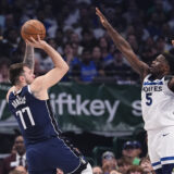 Dallas Mavericks guard Luka Doncic (77) shoots against Minnesota Timberwolves guard Anthony Edwards (5) during the first half in Game 4 of the NBA basketball Western Conference finals, Tuesday, May 28, 2024, in Dallas. (AP Photo/Julio Cortez)