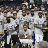 The Dallas Mavericks celebrate as they pose for a team photograph after Game 5 of the Western Conference finals in the NBA basketball playoffs against the Minnesota Timberwolves, Thursday, May 30, 2024, in Minneapolis. The Mavericks won 124-103, taking the series 4-1 and moving on to the NBA Finals. (AP Photo/Abbie Parr)