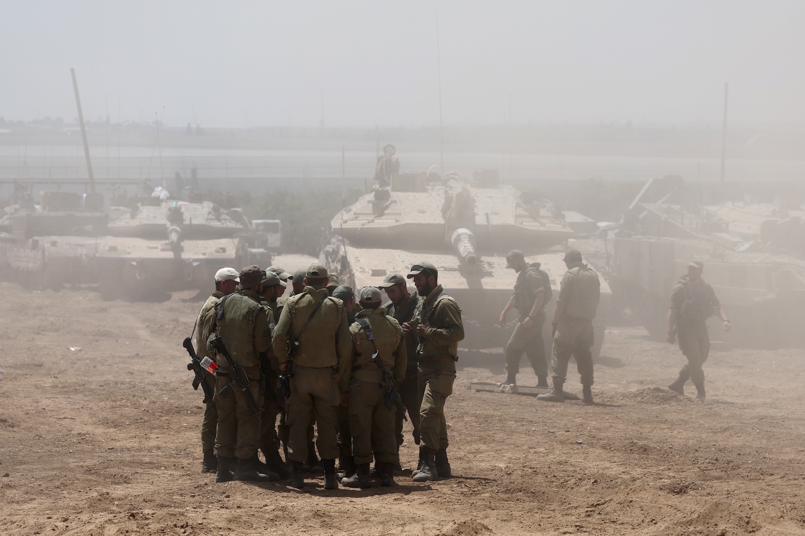 epa11328513 Israeli soldiers with military vehicles gather at an undisclosed position near the border fence with the Gaza Strip, in southern Israel, 09 May 2024. US Defense Secretary Austin at a Senate Appropriations Committee meeting on 08 May confirmed the Biden administration's decision to pause a shipment of 'high payload munitions' to Israel amid concerns over an Israeli major offensive in the southern Gaza city of Rafah. The Israeli military on 06 May called on residents of eastern Rafah to 'temporarily' evacuate to an expanded humanitarian area. On 07 May, Israel said that its troops began an operation targeting Hamas militants and infrastructure within specific areas of eastern Rafah, taking operational control of the Gazan side of the Rafah crossing. More than 34,800 Palestinians and over 1,455 Israelis have been killed, according to the Palestinian Health Ministry and the Israel Defense Forces (IDF), since Hamas militants launched an attack against Israel from the Gaza Strip on 07 October 2023, and the Israeli operations in Gaza and the West Bank which followed it.  EPA/ABIR SULTAN