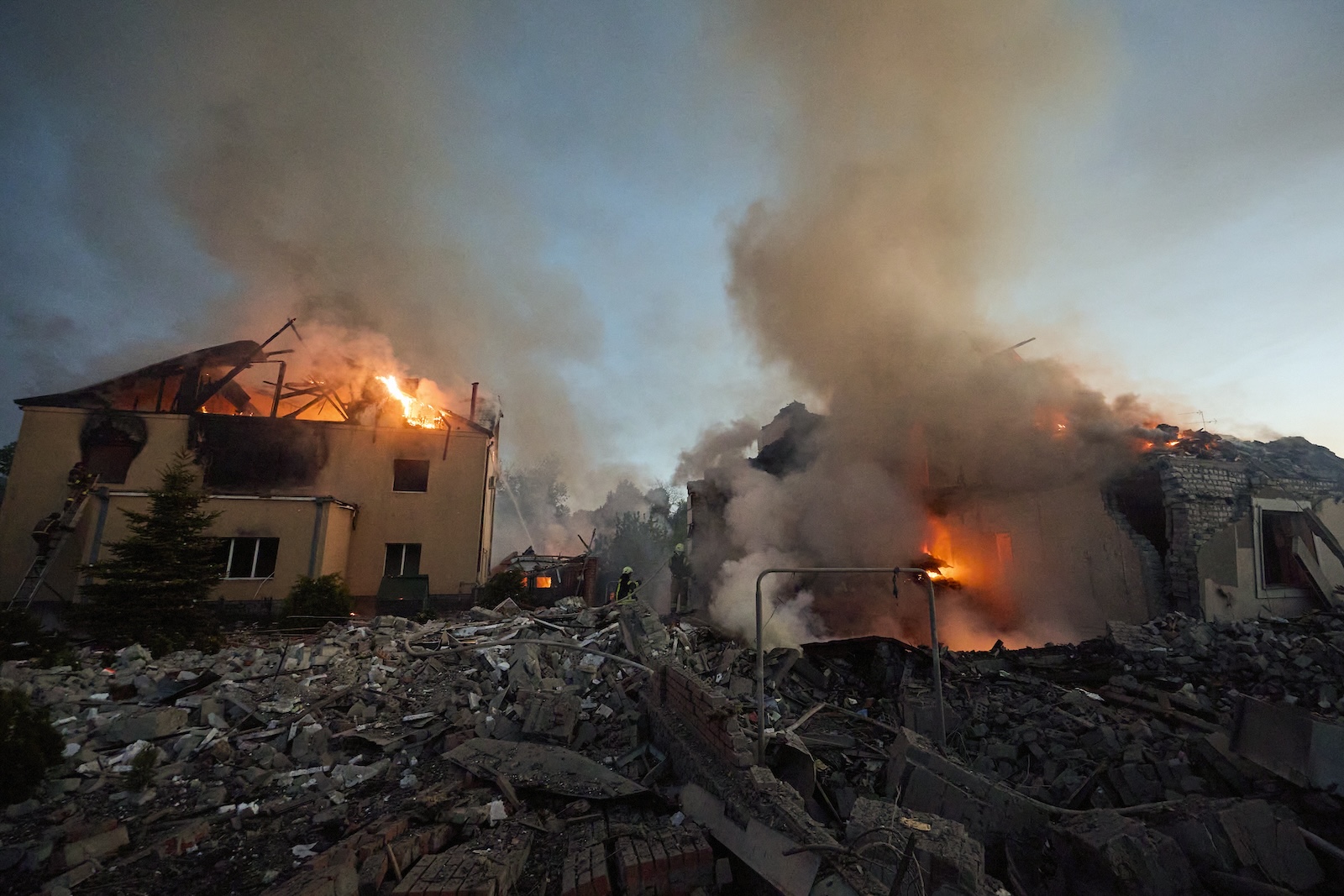 epa11330779 Ukrainian rescuers work to extinguish a fire at the site of an overnight missile strike on private buildings in Kharkiv, northeastern Ukraine, 10 May 2024, amid the Russian invasion. Kharkiv was hit by an S-300 missile at night, Mayor Ihor Terekhov wrote on telegram. At least two people, a 11-year-old child and a 72-year-old woman, were injured in the attack, according to the head of the Kharkiv Regional Military Administration, Oleg Synegubov. Russian troops entered Ukrainian territory on 24 February 2022, starting a conflict that has provoked destruction and a humanitarian crisis.  EPA/SERGEY KOZLOV