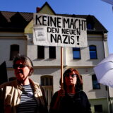 epa11338937 People carry a placard reading 'doing nothing makes the new Nazis' during a protest against the current leader of the far-right Alternative for Germany (AfD) political party in the state of Thuringia, Bjoern Hoecke, on the sidelines of his trial for using Nazi-era terminology, outside the court in Halle, Germany, 14 May 2024. Prosecutors accuse Hoecke of having concluded a political rally in Merseburg in 2021 by yelling out 'Alles fuer Deutschland' (Everything for Germany), a slogan used by Nazi-era SA stormtroopers, the use of which is a felony in modern Germany. The state of Thuringia is among three Eastern German states scheduled to hold state elections in September 2024, and in all three the AfD is currently leading in polls.  EPA/FILIP SINGER