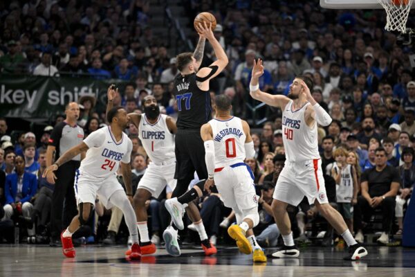 May 3, 2024; Dallas, Texas, USA; Dallas Mavericks guard Luka Doncic (77) passes the ball over LA Clippers guard Norman Powell (24) and guard James Harden (1) and guard Russell Westbrook (0) and center Ivica Zubac (40) during the first quarter during game six of the first round for the 2024 NBA playoffs at American Airlines Center. Mandatory Credit: Jerome Miron-USA TODAY Sports Photo: Jerome Miron/REUTERS