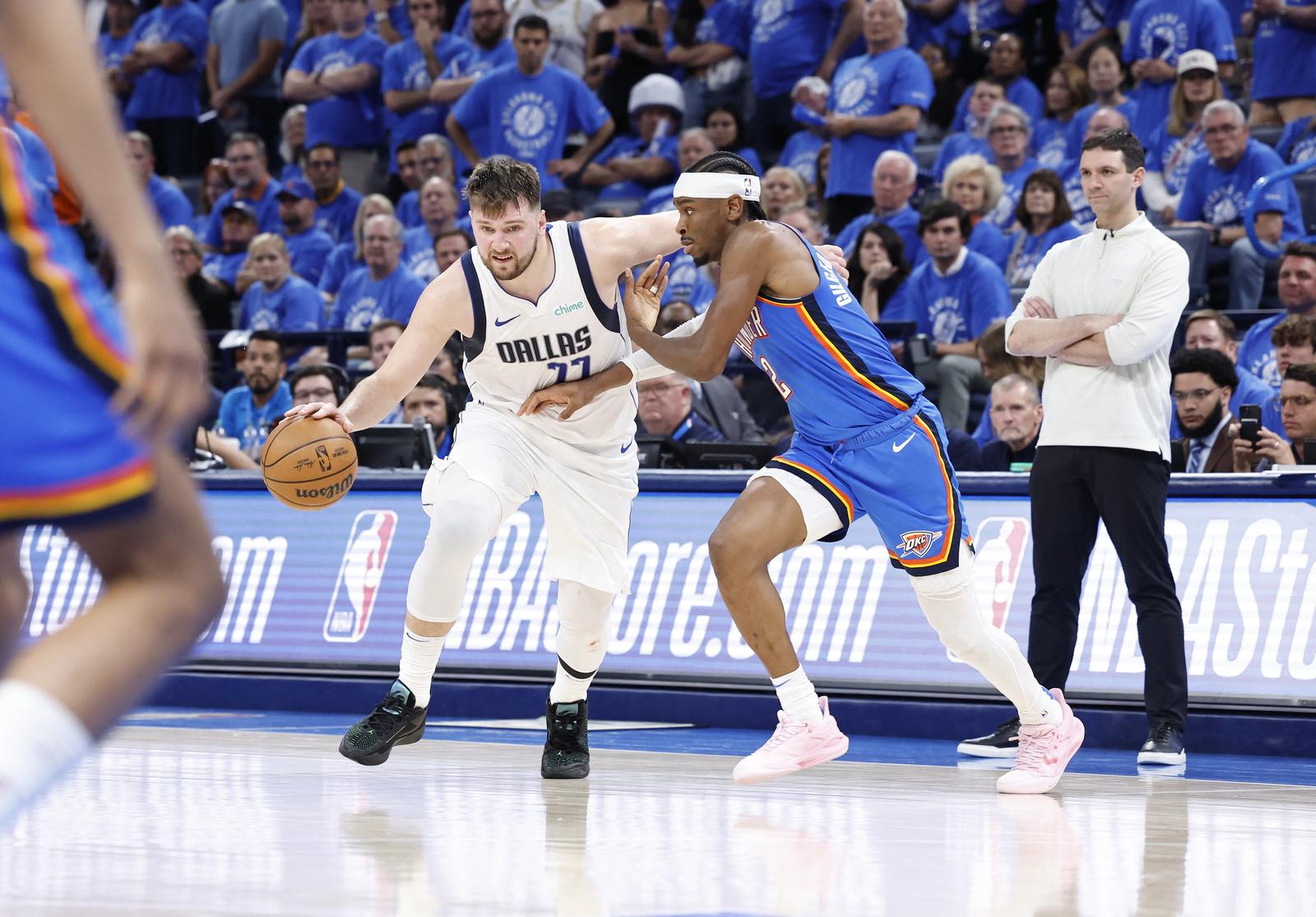 May 9, 2024; Oklahoma City, Oklahoma, USA; Dallas Mavericks guard Luka Doncic (77) moves past Oklahoma City Thunder guard Shai Gilgeous-Alexander (2) during the second half of game two of the second round for the 2024 NBA playoffs at Paycom Center. Mandatory Credit: Alonzo Adams-USA TODAY Sports Photo: Alonzo Adams/REUTERS