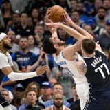 May 13, 2024; Dallas, Texas, USA; Dallas Mavericks guard Luka Doncic (77) fouls Oklahoma City Thunder forward Chet Holmgren (7) as center Daniel Gafford (21) looks on during the second half in game four of the second round for the 2024 NBA playoffs at American Airlines Center. Mandatory Credit: Jerome Miron-USA TODAY Sports Photo: Jerome Miron/REUTERS