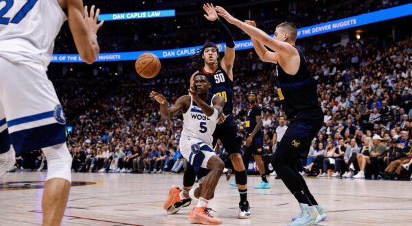 May 14, 2024; Denver, Colorado, USA; Minnesota Timberwolves guard Anthony Edwards (5) passes the ball to center Rudy Gobert (27) as Denver Nuggets forward Aaron Gordon (50) and center Nikola Jokic (15) defend in the second quarter during game five of the second round for the 2024 NBA playoffs at Ball Arena. Mandatory Credit: Isaiah J. Downing-USA TODAY Sports Photo: Isaiah J. Downing/REUTERS