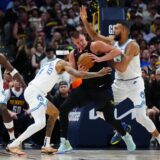 May 19, 2024; Denver, Colorado, USA; Minnesota Timberwolves center Rudy Gobert (27) and guard Nickeil Alexander-Walker (9) defend Denver Nuggets center Nikola Jokic (15) in the first half in game seven of the second round for the 2024 NBA playoffs at Ball Arena. Mandatory Credit: Ron Chenoy-USA TODAY Sports Photo: Ron Chenoy/REUTERS