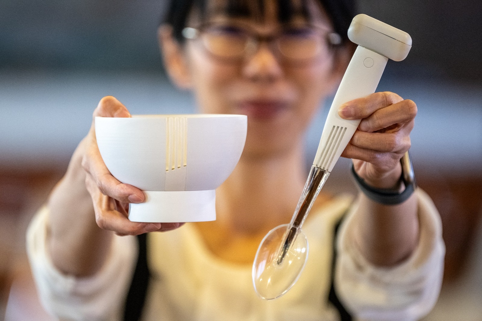 This picture taken on November 20, 2023 shows Ai Sato, from the health science business division of Kirin Holdings, displaying a spoon and bowl that enhance the salty taste of low-sodium food, at the city hall in Odawara, Kanagawa prefecture, south of Tokyo. The spoons and bowls were developed to help people who are trying to reduce salt intake, yet still enjoy traditionally salty dishes like ramen noodles and Japanese miso soup.,Image: 848971278, License: Rights-managed, Restrictions: , Model Release: no, Credit line: Philip FONG / AFP / Profimedia