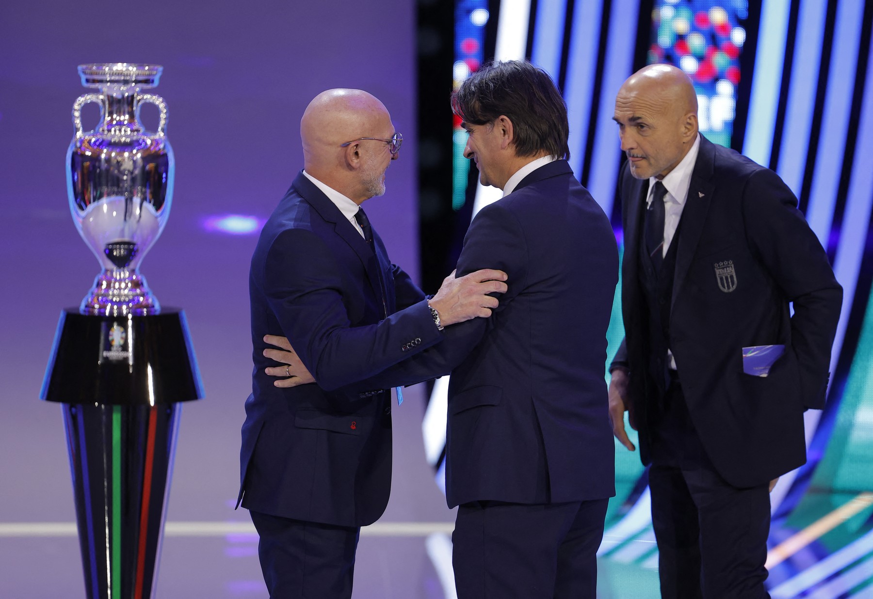 (L to R) Spain's head coach Luis de la Fuente greets Croatia's head coach Zlatko Dalic next to Italy's head coach Luciano Spalletti next to the trophy after the final draw for the UEFA Euro 2024 European Championship football competition in Hamburg, northern Germany on December 2, 2023.,Image: 826197303, License: Rights-managed, Restrictions: , Model Release: no, Credit line: Odd ANDERSEN / AFP / Profimedia