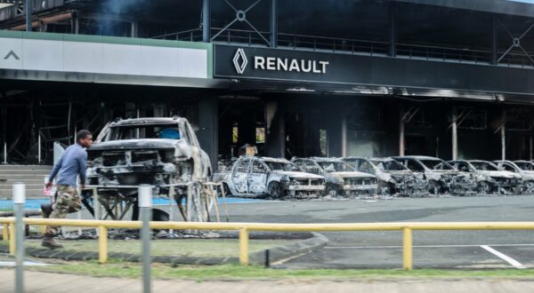 This photograph shows a view of burnt cars and a burnt Renault car shop amid protests linked to a debate on a constitutional bill aimed at enlarging the electorate for upcoming elections in the overseas French territory of New Caledonia, in Noumea, on May 14, 2024. After scenes of violence of 