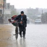 A displaced Palestinian man pushes a bycicle bearing his belongings in the rain in Rafah in the southern Gaza Strip following an evacuation order by the Israeli army on May 6, 2024, amid the ongoing conflict between Israel and the Palestinian Hamas movement.,Image: 870590635, License: Rights-managed, Restrictions: , Model Release: no, Credit line: AFP / AFP / Profimedia