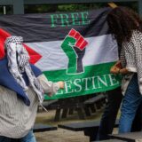 epa11336873 Pro-Palestinian students at Vrije Universiteit Brussel (Free University of Brussels, or VUB) set up a Palestinian flag as they occupy a building on Etterbeek campus, in Brussels, Belgium, 13 May 2024. The Palestine Solidarity Network student group announced the occupation of a VUB building in Etterbeek as part of a series of international protests demanding the severing of all academic ties with Israel amidst the escalating conflict in the Gaza Strip.  EPA/OLIVIER MATTHYS