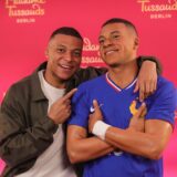 epa11345316 French soccer player Kylian Mbappe (L) poses with his Madame Tussauds wax figure during the unveiling in Paris, France, 16 May 2024. The Madame Tussauds museum will move the Mappe wax figure to it's Berlin, Germany, location at a later date.  EPA/Teresa Suarez